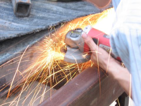 1974 Ford F-100 - Sparks fly as metal is cut with an angle grinder.