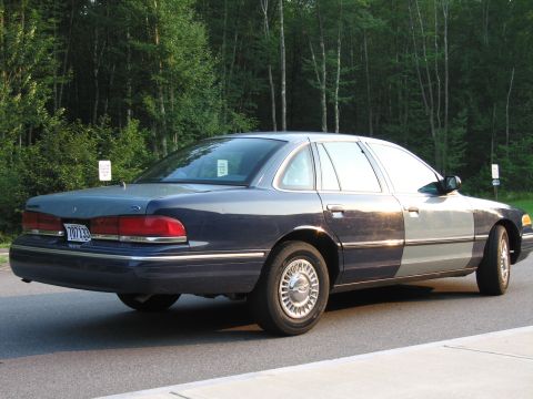 1991 Ford LTD Crown Victoria - This 1991 Ford Crown Victoria LTD sedan is seen from the rear three-quarter angle, a distinctive two-tone paint scheme.