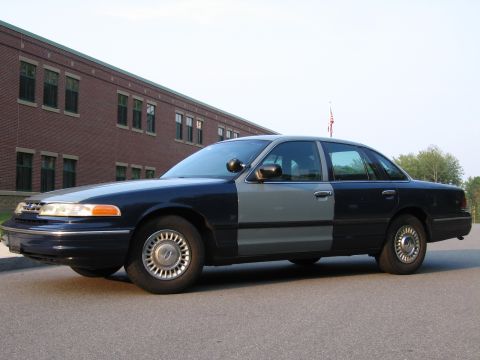 1991 Ford LTD Crown Victoria - This sedan has a two-tone paint job with the front half gray and the rear half dark blue.