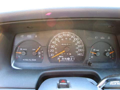 1991 Ford LTD Crown Victoria - Interior view of a vehicle's dashboard gauges, including the speedometer, fuel level, voltage meter, and temperature and oil indicators.