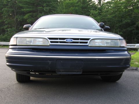 1991 Ford LTD Crown Victoria - Frontal view of a blue 1991 Ford Crown Victoria LTD, showing its distinctive grille and headlights.