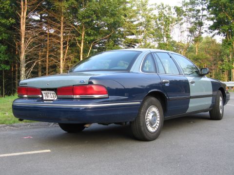 1991 Ford LTD Crown Victoria - This Ford Crown Victoria, likely from the mid-1990s, has a two-tone paint job and is parked on the side of a road.