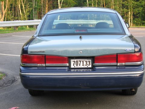 1991 Ford LTD Crown Victoria - This 1991 Ford Crown Victoria LTD sedan is seen from the rear, a two-tone blue and grey paint scheme.
