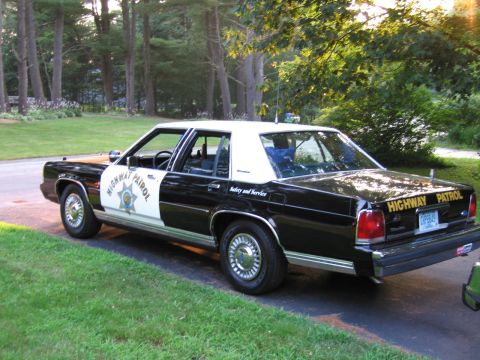 1991 Ford LTD Crown Victoria - This 1991 Ford Crown Victoria LTD highway patrol car is seen from a 3/4 front view, parked outdoors.