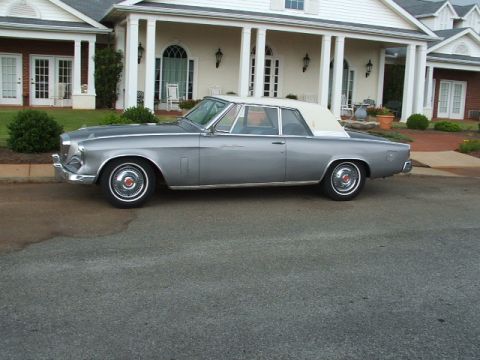 1966 Ford Ranchero - This 1961 Studebaker Hawk convertible is parked on a street in front of a large house.