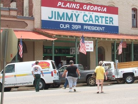 1966 Ford Ranchero - A street view of the Jimmy Carter Presidential Library and Museum in Plains, Georgia, with several people walking by.
