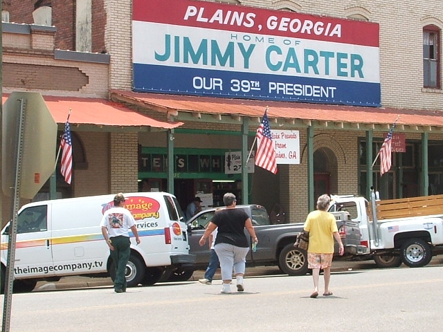Jimmy Carter Presidential Library and Museum in Plains, Georgia, with a white van and a pickup truck parked outside
