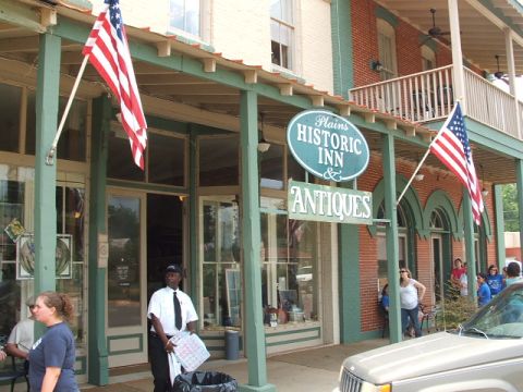 1966 Ford Ranchero - A historic inn and antique shop is shown with American flags flying outside.