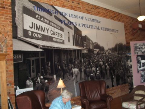 1966 Ford Ranchero - A large mural depicts a political event in Plains, Georgia, with a crowd gathered on a street.