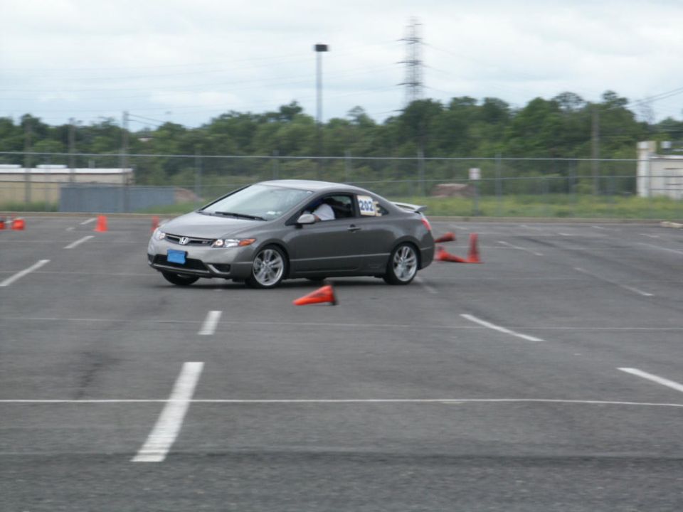 Gray Honda Civic Coupe with racing number 202 on the side, on a track with orange cones