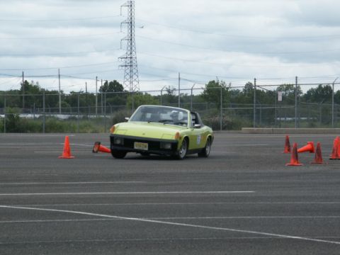 2001 Mercury Grand Marquis - Yellow Porsche 914 navigates a cone course on a cloudy day.