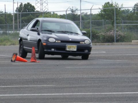 2001 Mercury Grand Marquis - A dark blue coupe navigates an asphalt course marked by orange traffic cones.