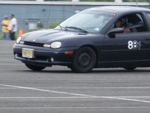 2001 Mercury Grand Marquis - A dark blue sedan, marked with the number 881, navigates a track during an event.