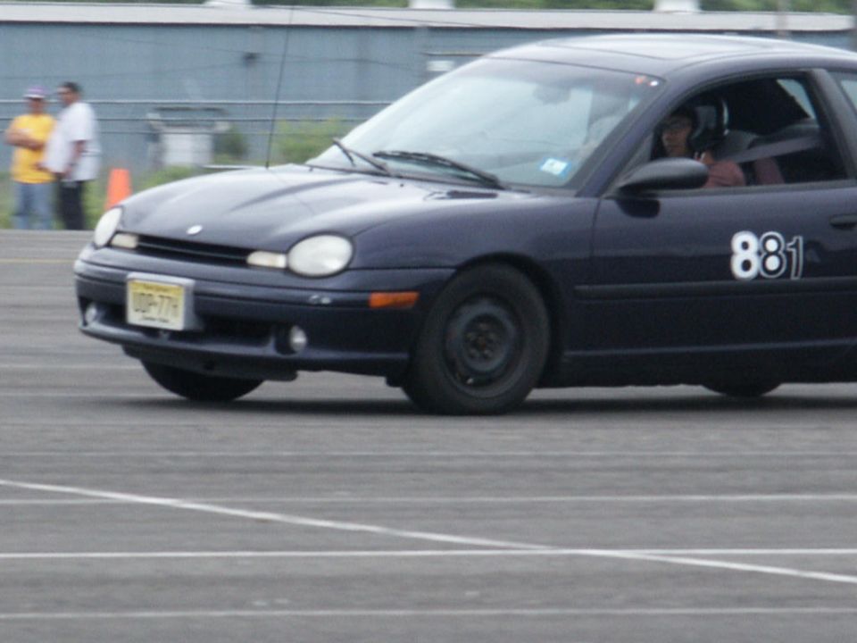 Dark blue sedan with number 881 on the side, seen from the front-three-quarter view