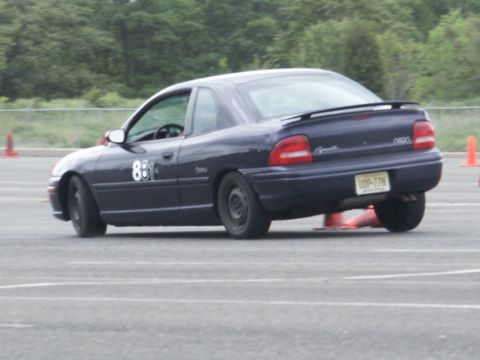 2001 Mercury Grand Marquis - Plymouth Neon coupe with number 88 on door, seen on a race track.