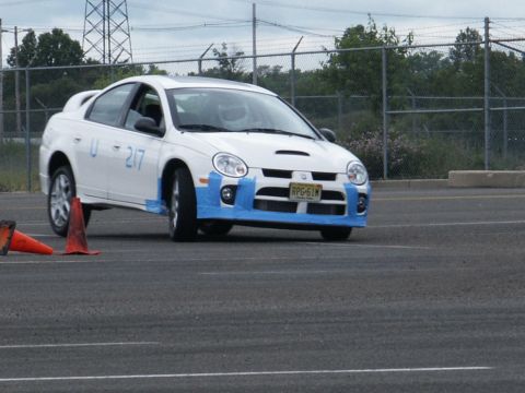 2001 Mercury Grand Marquis - A white Dodge Neon SRT-4 is seen on a track with cones, possibly during a timed event.