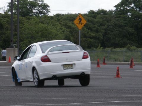 2001 Mercury Grand Marquis - White Dodge Neon SRT-4 navigates a course marked by orange cones.