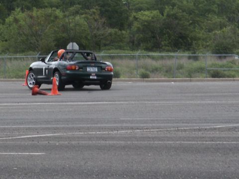 2001 Mercury Grand Marquis - A dark green convertible navigates a course marked by traffic cones on an asphalt surface.