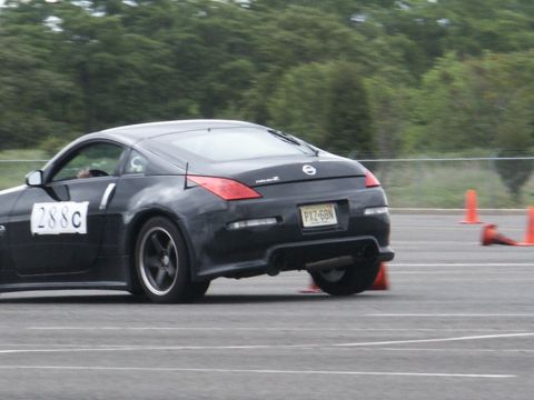 2001 Mercury Grand Marquis - A black Nissan 350Z navigates a course marked by orange cones.