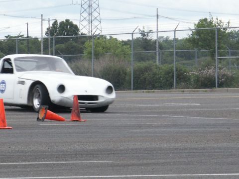 2001 Mercury Grand Marquis - A white sports car is seen on a track, maneuvering around orange cones during a timed event.