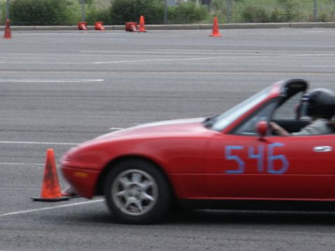2001 Mercury Grand Marquis - A red convertible with the number 546 painted on its side navigates a course marked by orange traffic cones.