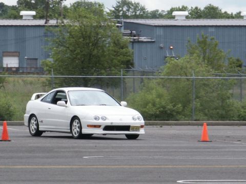 2001 Mercury Grand Marquis - A white Acura Integra coupe navigates a course marked by orange traffic cones on a cloudy day.