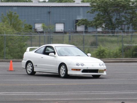 2001 Mercury Grand Marquis - A white Acura Integra Type R coupe is seen on a race track with an orange cone nearby.