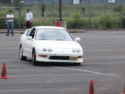 2001 Mercury Grand Marquis - A white coupe with pop-up headlights navigates a course marked by orange cones.