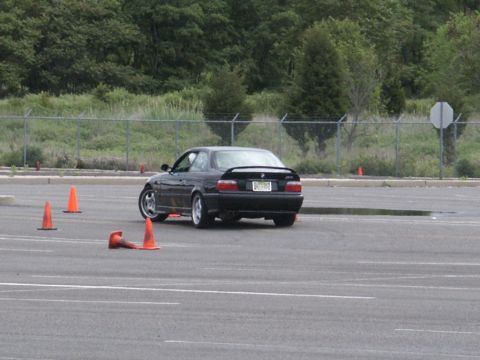 2001 Mercury Grand Marquis - A black coupe navigates a course marked by orange cones on a paved lot.