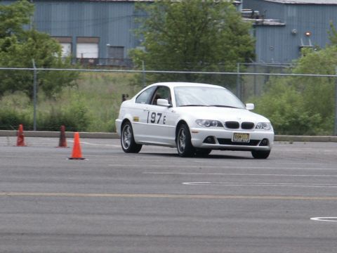 2001 Mercury Grand Marquis - White BMW 3 Series coupe with racing numbers on the door navigates a course marked by orange cones.