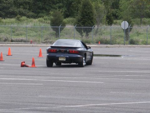 2001 Mercury Grand Marquis - A dark blue coupe with a spoiler navigates a course marked by orange cones. The license plate is visible.