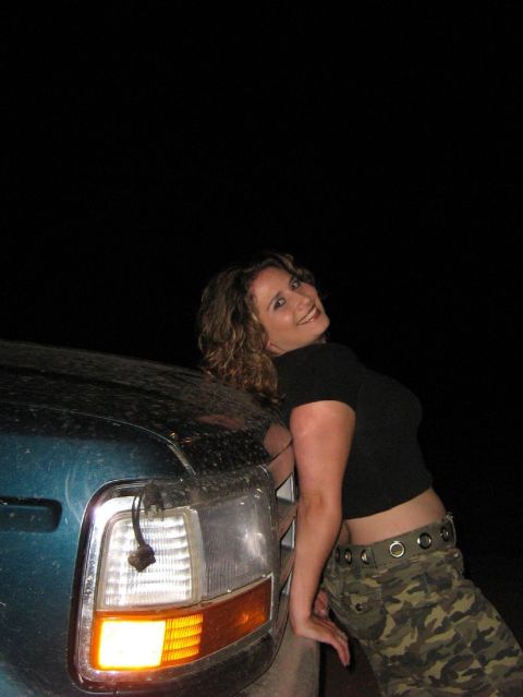 1995 Ford Bronco - Woman poses with a 1997 Ford F-250 truck.