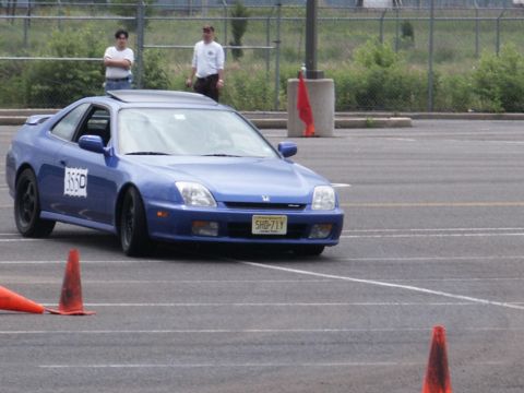 2001 Mercury Grand Marquis - A blue coupe navigates a course marked by orange cones on a paved surface.