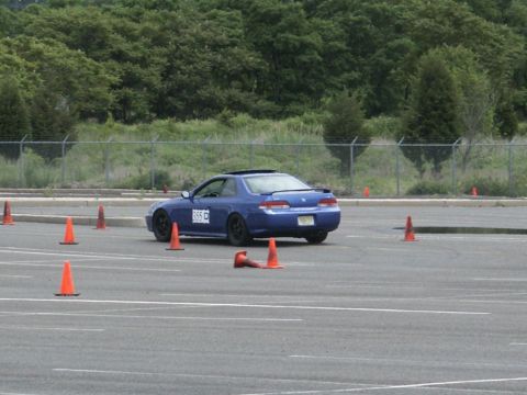 2001 Mercury Grand Marquis - A blue coupe navigates a cone course on a paved track.