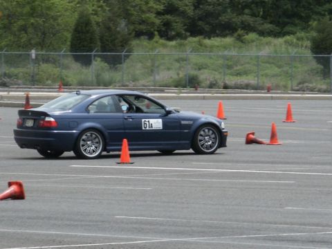 2001 Mercury Grand Marquis - A blue coupe navigates a course marked by orange cones, displaying racing number 61A.