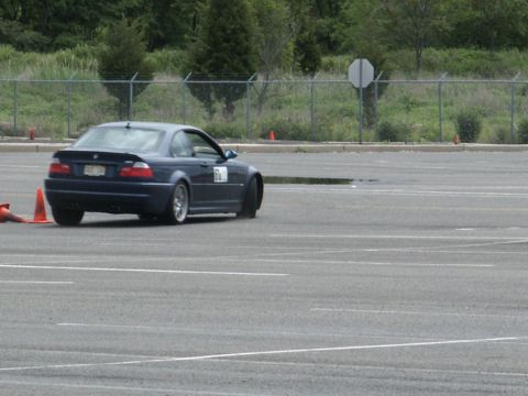 2001 Mercury Grand Marquis - BMW M3 coupe navigates a course marked by orange cones on a paved lot.