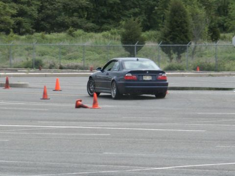 2001 Mercury Grand Marquis - A dark blue coupe navigates a course marked by orange traffic cones on a paved lot.