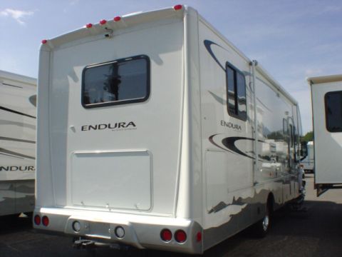 2005 Chevrolet C-6500/Kodiak - Rear view of a white RV with 'ENDURA' badging, parked next to another RV.