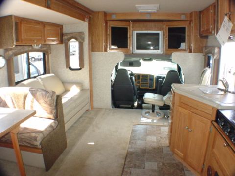 2005 Chevrolet C-6500/Kodiak - Interior view of a recreational vehicle, showing the living area and the driver's cockpit.
