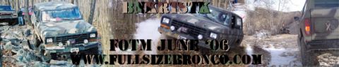 1996 Ford Bronco - Multiple Ford Broncos navigate a challenging off-road course in a wooded area.