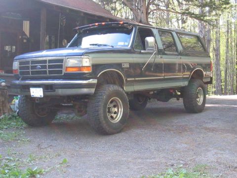 1979 Ford Bronco - This lifted Ford F-Series truck, likely from the early to mid-1990s, is shown in a three-quarter front view.