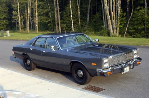 1978 Dodge Monaco - This 1978 Dodge Monaco is shown in a three-quarter front view, highlighting its distinctive grille and dark gray exterior.