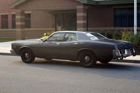 1978 Dodge Monaco - This sedan appears to be a police car, possibly a 1977 model, parked on a street.