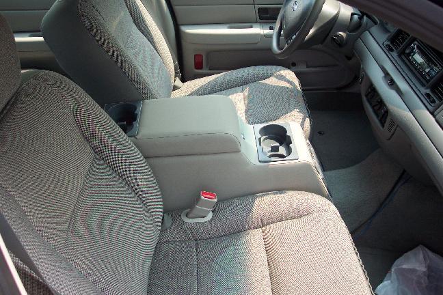 Gray cloth interior with center console cup holders and red seatbelt buckle