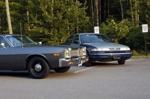 1978 Dodge Monaco - A 1978 Dodge Monaco is parked in front of a blue and gray sedan with trees in the background.