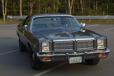 1978 Dodge Monaco - This sedan features a prominent chrome grille and dual rectangular headlights, with a license plate indicating it's an antique vehicle.