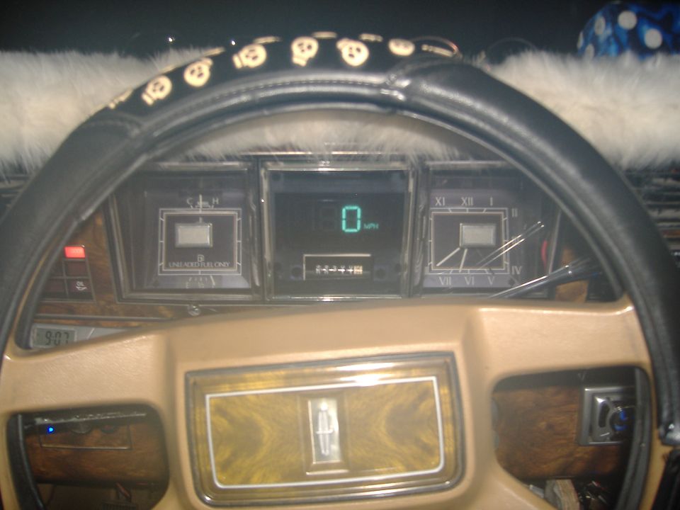 1983 Lincoln Town Car dashboard with digital speedometer showing 0 mph and wood grain trim