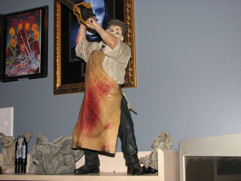 1991 Ford Bronco - A figure resembling Leatherface from The Texas Chainsaw Massacre is displayed, holding a chainsaw and wearing a blood-stained apron.