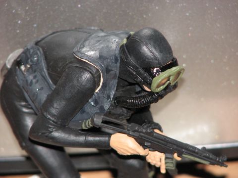 1991 Ford Bronco - A detailed action figure depicts a diver equipped with scuba gear and a firearm, posed in a crouched position.