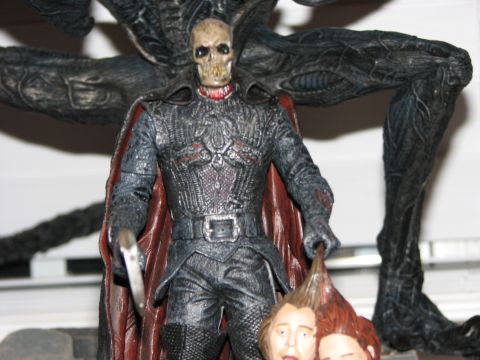 1991 Ford Bronco - A detailed action figure depicts a skeletal character in dark armor, holding a weapon and a severed head.